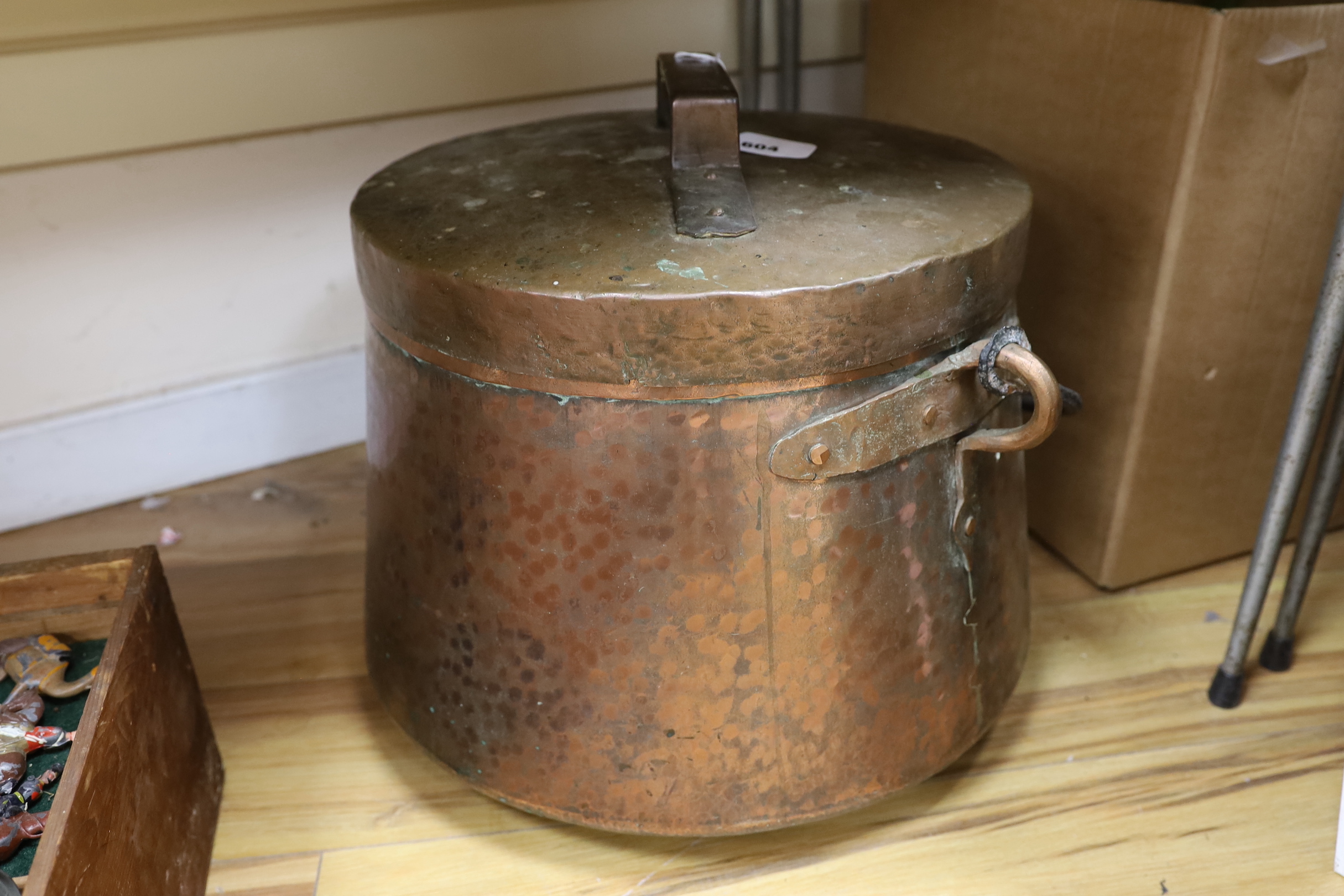 A large hammered copper cauldron and cover, 35cm high not including handle on cover